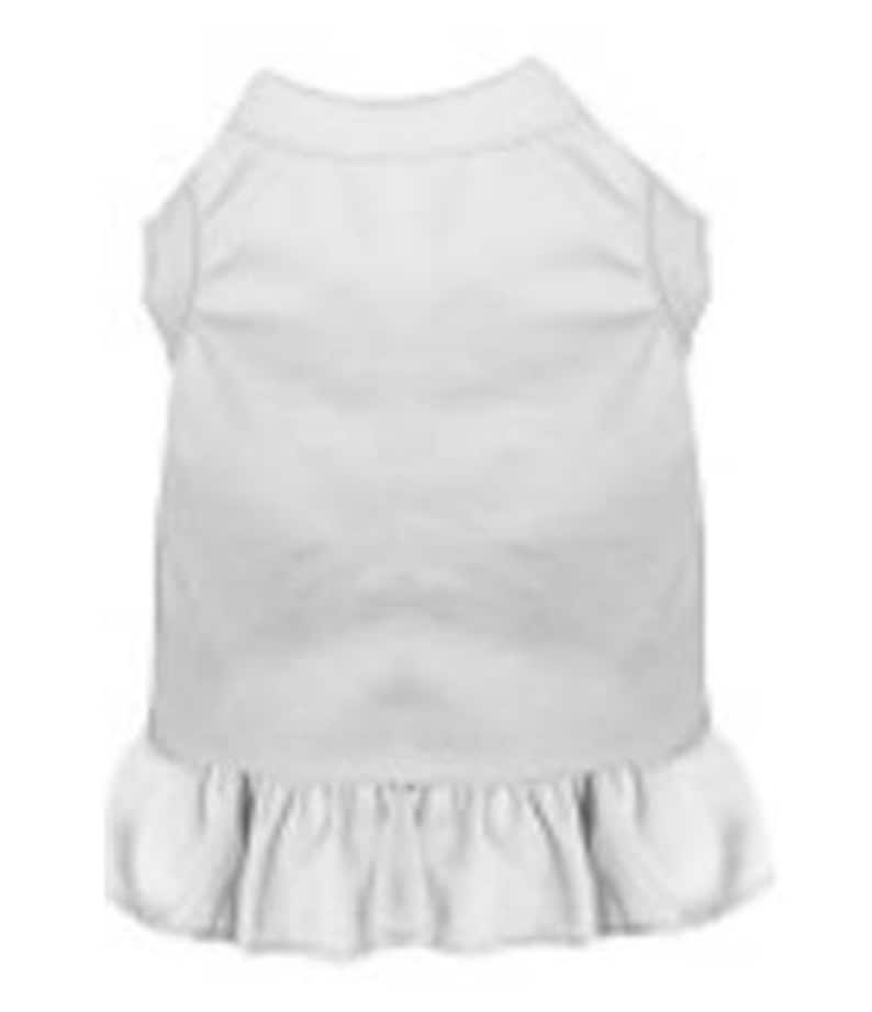 May include: White sleeveless dog dress with a ruffled hem.