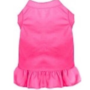May include: A bright pink sleeveless dog dress with a ruffled hem.