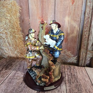 Statue of a firefighter handing a puppy out of a burning building to another fireman - 3D Resin Decorative figurine