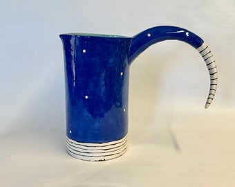 Big Bright Blue ceramic Pitcher w/ black beetle juice stripes & whimsical handle