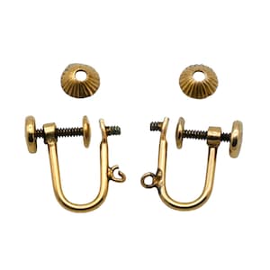 May include: A pair of gold-toned screw-back earring findings, with two additional decorative caps. The findings have a U-shaped design with a screw mechanism for secure attachment. The caps are small and round with a ridged pattern.