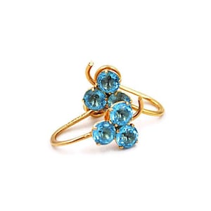 May include: Gold earrings with a cluster of five blue topaz stones.