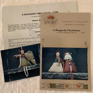 May include: A Raggedy Christmas craft pattern with instructions and a photo of handmade dolls. The photo shows a snowman and Santa doll. The pattern includes a list of materials and cutting instructions for the dolls.