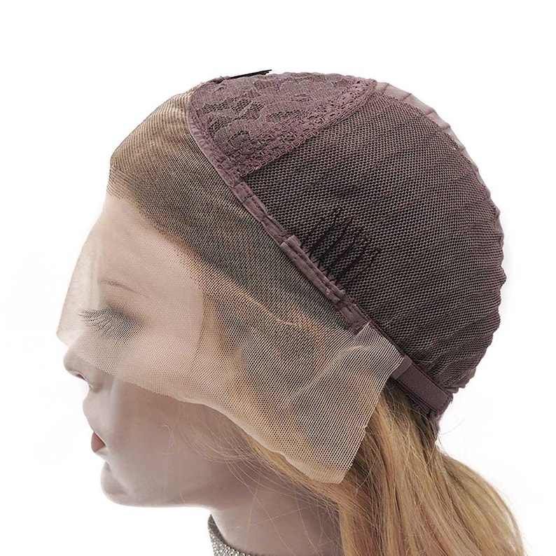 May include: A brown lace front wig cap with a mesh base. The cap features a lace front that extends across the forehead and a brown mesh back. The wig cap is designed to be worn under a wig to protect the natural hair.