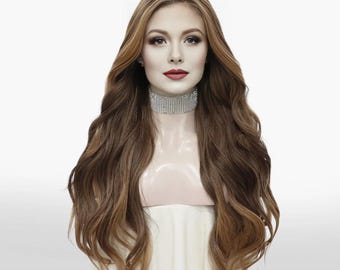 May include: A long, wavy wig with a blend of brown and blonde tones. The wig features a natural-looking hairline and is styled with voluminous waves. The model is wearing a sparkling rhinestone choker. The wig is displayed on a mannequin head.