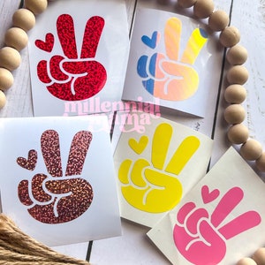 May include: A white ceramic mug with a black handle and the text "But First, Coffee" in a bold, black font. The mug is sitting on a wooden surface. The mug appears to be 12 ounces.