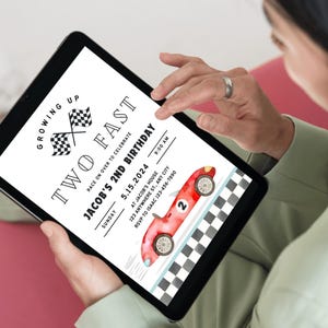 May include: A digital invitation for a child's second birthday party. The invitation features a red race car with a checkered flag background and the text "Growing Up Two Fast" and "Jacob's 2nd Birthday".