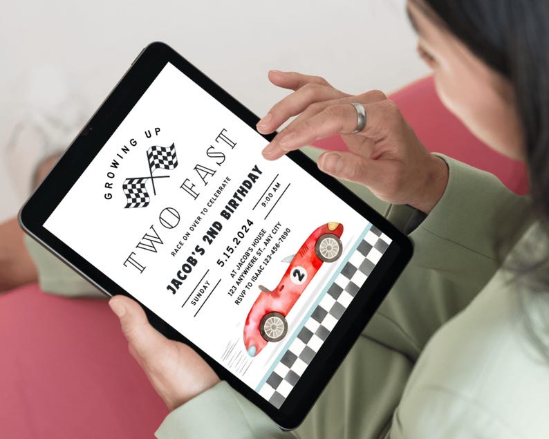 May include: A digital invitation for a child's second birthday party. The invitation features a red race car with a checkered flag background and the text "Growing Up Two Fast" and "Jacob's 2nd Birthday".