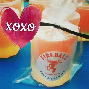 May include: Orange-colored shot glass soap with a "Fireball Cinnamon Whiskey" label, wrapped in clear cellophane and tied with a black ribbon. The image includes a pink heart with the text "xoxo".
