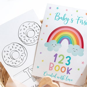 May include: A colorful rainbow with clouds and stars on a white background. The text "Baby's First 123 Book Created with love" is printed below the rainbow.