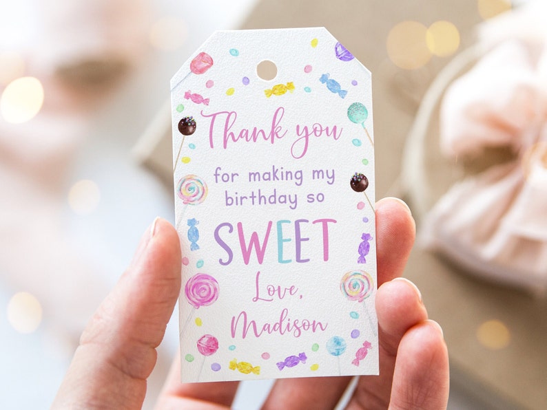 May include: White thank you tag with a candy theme. The tag says "Thank you for making my birthday so SWEET. Love, Madison".