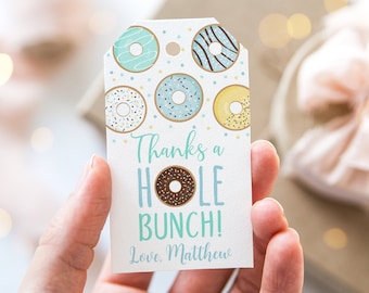 May include: A white gift tag with a blue and yellow donut pattern. The tag says "Thanks a hole bunch! Love, Matthew".