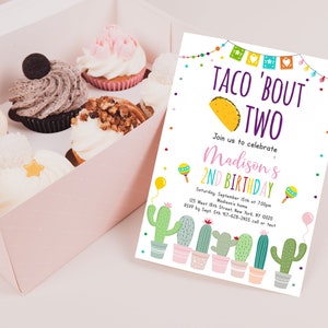 May include: A colorful invitation for a 2nd birthday party with a taco theme. The invitation says "Taco 'Bout Two" and features a cartoon taco, cactus plants, and maracas. The text includes the birthday girl's name, date, time, and location.