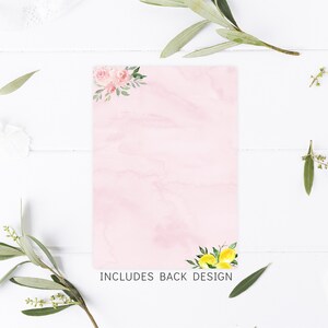 May include: A pink card with a watercolor design of pink flowers in the top corner and lemons in the bottom corner. The text "INCLUDES BACK DESIGN" is printed at the bottom of the card.