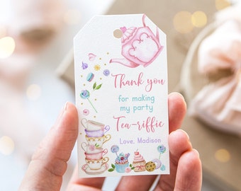 May include: Pink and white thank you tag with a teapot pouring tea, stacked teacups, cupcakes, and lollipops. The text reads "Thank you for making my party tea-riffic. Love, Madison."