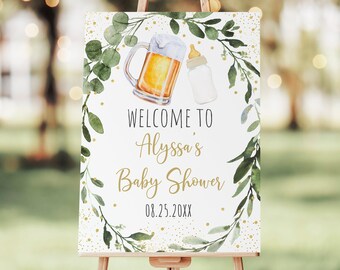 May include: Welcome to Alyssa's Baby Shower sign with a green leafy wreath, a beer mug, and a baby bottle. The sign has gold glitter accents and the date 08.25.20XX.