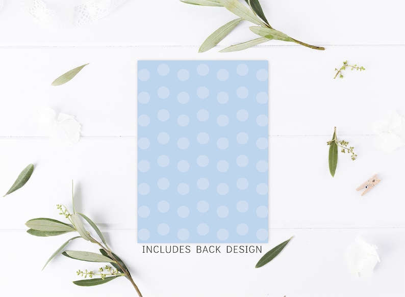 May include: A light blue card with white polka dots. The text "INCLUDES BACK DESIGN" is printed at the bottom of the card.