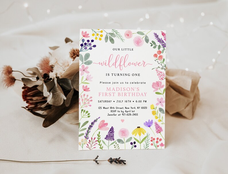 May include: A watercolor floral birthday invitation with a pink and white background. The text reads "Our little wildflower is turning one. Please join us to celebrate Madison's first birthday. Saturday, July 16th, 6:00 PM. 125 West 18th Street, New York, NY 10020. RSVP to by April 1st. Jennifer at 97-628-2455."