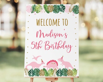 May include: Welcome to Madison's 5th Birthday sign featuring pink dinosaurs and green leaves on a white background.