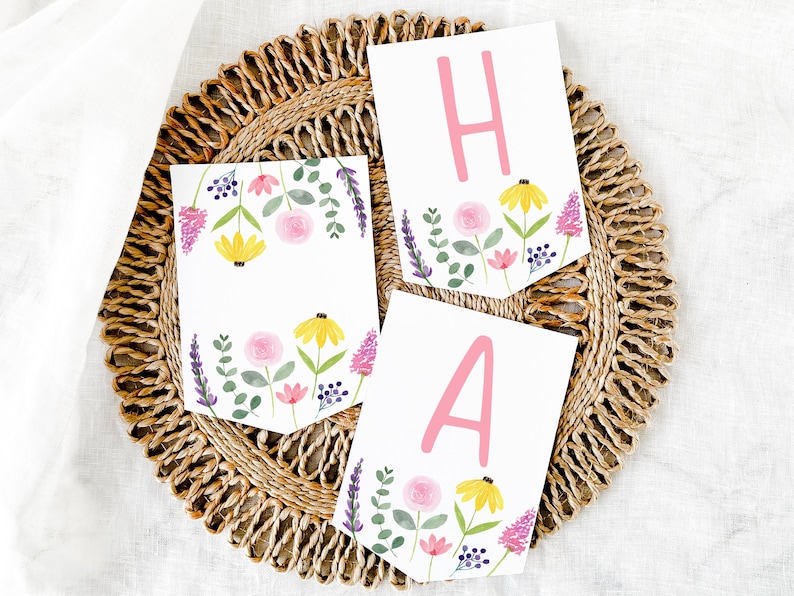 May include: A floral banner with the letters "HA" in pink on a white background. The banner is decorated with watercolor flowers in shades of pink, yellow, and purple.