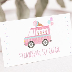 May include: A pink ice cream truck with a white roof and blue accents. The truck has a cone of ice cream on top and balloons. The text "STRAWBERRY ICE CREAM" is printed below the truck.