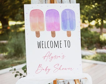 May include: A white welcome sign with a watercolour illustration of three popsicles in pink, purple, and blue. The text "Welcome to Alyssa's Baby Shower" is written in pink cursive.