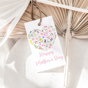 May include: White card with a pink heart filled with colorful flowers and the text "Happy Mother's Day" in pink lettering.