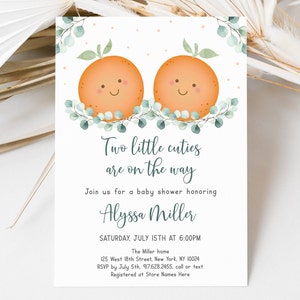 May include: A baby shower invitation with a watercolor illustration of two orange slices with smiling faces. The text reads "Two little cuties are on the way" and includes the name "Alyssa Miller" and the date "Saturday, July 15th at 6:00PM".