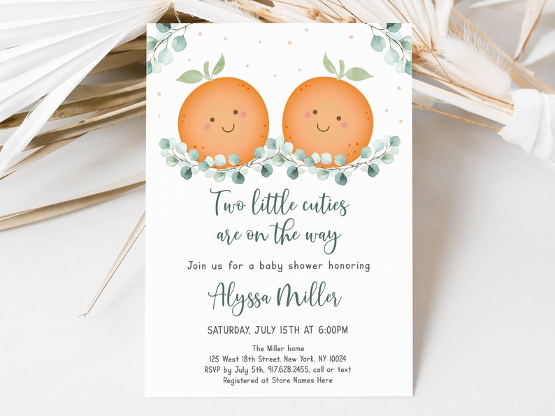 May include: A baby shower invitation with a watercolor illustration of two orange slices with smiling faces. The text reads "Two little cuties are on the way" and includes the name "Alyssa Miller" and the date "Saturday, July 15th at 6:00PM".