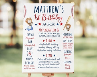 May include: A white sign with red and blue baseball-themed decorations announcing Matthew's 1st birthday. The sign lists details about Matthew, including his weight (25 pounds), height (30 inches), favorite foods, and favorite book. The sign also includes a list of things Matthew can do, such as clap his hands and wave hi.