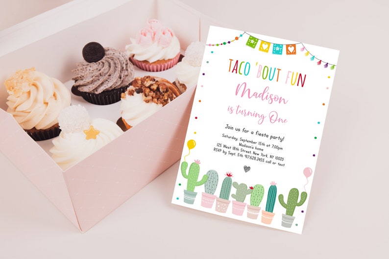 May include: A colorful invitation for a first birthday party with the text "Taco 'Bout Fun Madison is turning One". The invitation features a cactus theme with green cacti in pots and colorful paper flags.