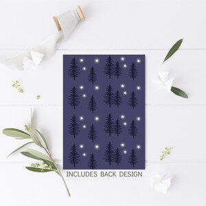 May include: A dark blue card with a repeating pattern of white stars and black silhouette trees. The text "INCLUDES BACK DESIGN" is printed at the bottom of the card.