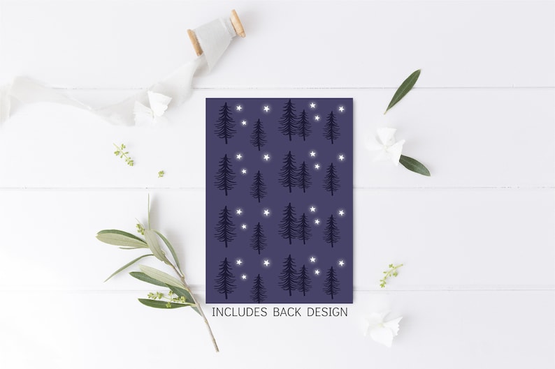 May include: A dark blue card with a repeating pattern of white stars and black silhouette trees. The text "INCLUDES BACK DESIGN" is printed at the bottom of the card.