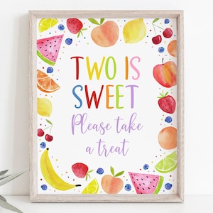 May include: A colorful printable sign with a fruit theme. The sign says "Two is Sweet" and "Please take a treat". The sign is surrounded by a border of watermelon, lemons, peaches, strawberries, cherries, bananas, and limes.