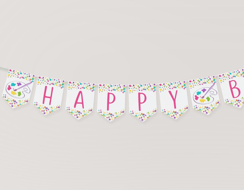 May include: A white banner with pink letters spelling "HAPPY" and a paint palette with a paintbrush on each end. The banner has a colorful confetti pattern.