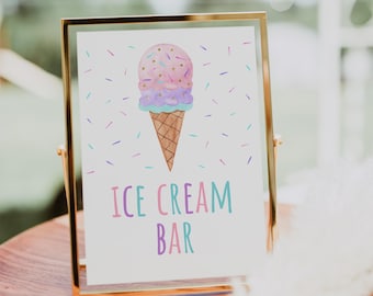 May include: A gold-framed sign with a watercolor illustration of an ice cream cone with pink, purple, and blue ice cream and sprinkles. The sign reads "ICE CREAM BAR" in pink, blue, and green lettering.