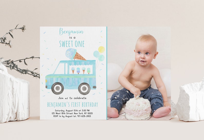 May include: A blue and white ice cream truck with ice cream cones and popsicles on top. The truck is on a light blue background with yellow and white sprinkles. The text "Benjamin is a SWEET ONE" is at the top of the card. The text "Join us to celebrate BENJAMIN'S FIRST BIRTHDAY" is below the truck. The text "Saturday, August 15th at 3:00 PM 125 West 18th Street, New York, NY 10020 RSVP to by August 1st. 917-628-2455" is at the bottom of the card.
