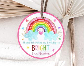 May include: Round pink and white thank you tag with a rainbow, clouds, and gold glitter. The text reads "Thanks for making my birthday so BRIGHT Love, Madison".
