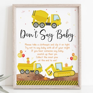 May include: A printable game card for a baby shower party. The card features a yellow construction truck and the text "Don't Say Baby". The instructions are to take a clothespin and try not to say the word "baby" during the party. Whoever says "baby" the least wins.