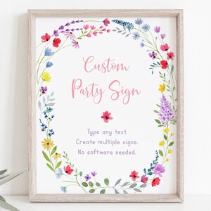 May include: A printable sign with a floral wreath border. The text reads "Custom Party Sign" in pink lettering. The text below reads "Type any text. Create multiple signs. No software needed."