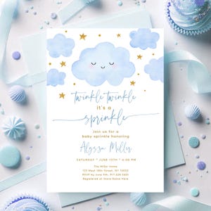 May include: Baby sprinkle invitation with a watercolor design. The invitation features blue clouds, gold stars, and the text "Twinkle Twinkle it's a sprinkle." The invitation includes the honoree's name, date, time, and location.