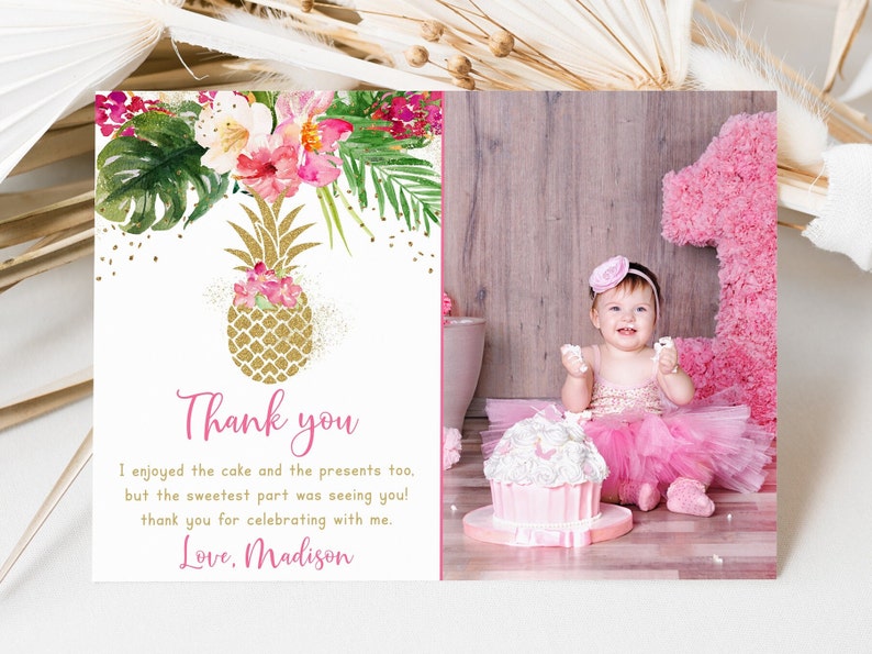 May include: A pink and gold thank you card with a pineapple design and a photo of a baby girl in a pink tutu and a pink headband. The text on the card reads "Thank you. I enjoyed the cake and the presents too, but the sweetest part was seeing you! Thank you for celebrating with me. Love, Madison."