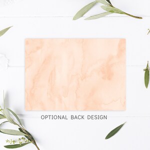 May include: A peach-colored card with a watercolor background. The card has the text "OPTIONAL BACK DESIGN" printed on it.