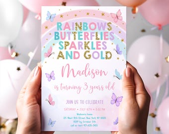 May include: A party invitation with a pastel rainbow, butterflies, and gold accents. The invitation reads "Rainbows, Butterflies, Sparkles, and Gold" and announces "Madison is turning 3 years old." The invitation includes event details.