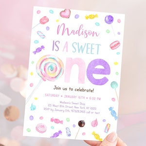 May include: A pastel-colored invitation with the text "Madison IS A SWEET ONE." The invitation features watercolor illustrations of candies, lollipops, and macarons. The invitation includes event details: date, time, and location.