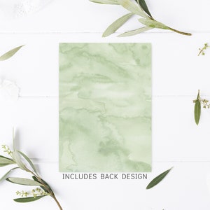 May include: A green watercolor background with a white border. The text "INCLUDES BACK DESIGN" is printed at the bottom of the card.