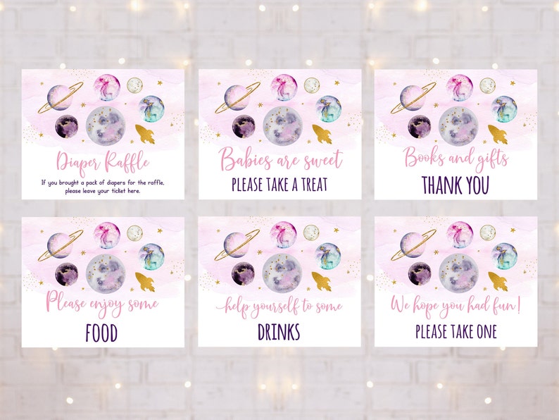 May include: Six pink and gold space-themed baby shower signs with watercolor planets and stars. The signs say "Diaper Raffle", "Babies are sweet, Please take a treat", "Books and gifts, Thank you", "Please enjoy some food", "Help yourself to some drinks", and "We hope you had fun! Please take one".