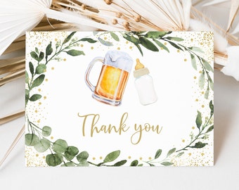 May include: Thank you card with a green leafy wreath and gold glitter. The wreath surrounds a watercolor illustration of a beer mug and a baby bottle.