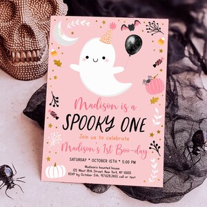 May include: Pink and gold Halloween party invitation featuring a cute ghost wearing a party hat and holding a black balloon. The text reads "Madison is a Spooky One. Join us to celebrate Madison's 1st Boo-day. Saturday, October 15th, 5:00 PM. Madison's haunted house, 125 West 18th Street, New York, NY 10020. RSVP by October 5th, 917.628.2455 call or text."