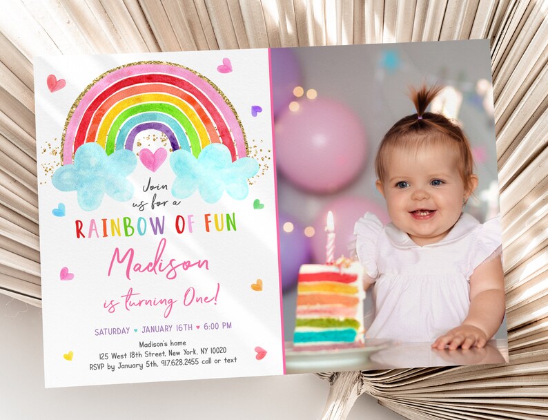 May include: A rainbow-themed first birthday party invitation with a watercolor rainbow, clouds, and hearts. The invitation says "Join us for a Rainbow of Fun Madison is turning One!" with the date, time, and location information below. A photo of a baby girl is in the background.